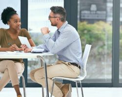 male and female talking at a table about careers services