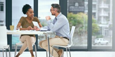 male and female talking at a table about careers services