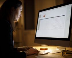 Serious woman working late at home on laptop