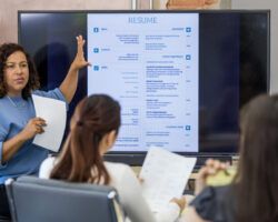 Mid adult human resources representative leads a resume building class