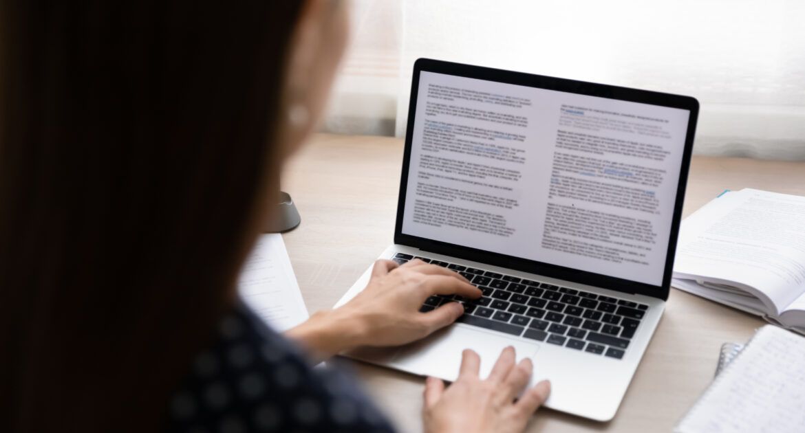 woman working on article on laptop