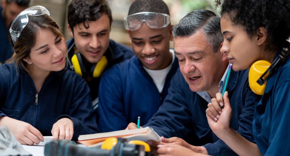 Teacher talking to a group of industrial design students