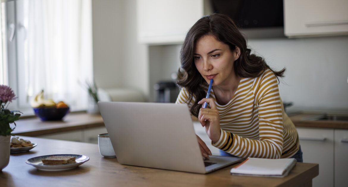 Young woman using a laptop while working from home