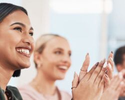 Navigate your career - Shot of a group of businesspeople clapping during a meeting in a modern office