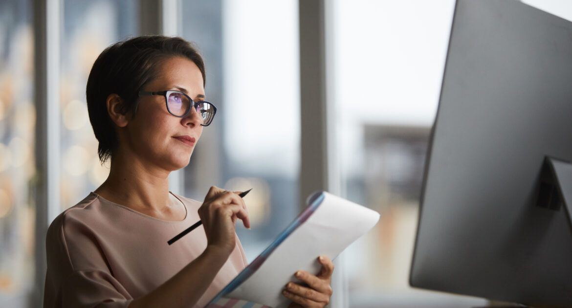 Woman thinking at laptop