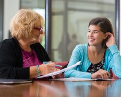 female student meeting with academic advisor